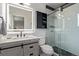 Modern bathroom features a glass shower, a vanity, and geometric tile floors at 618 Fairchild Dr, Highlands Ranch, CO 80126