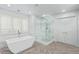 Bright bathroom featuring a glass-enclosed shower and a modern soaking tub at 618 Fairchild Dr, Highlands Ranch, CO 80126