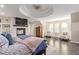 Spacious bedroom featuring a fireplace, sitting area, and tray ceiling at 618 Fairchild Dr, Highlands Ranch, CO 80126