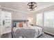 Bright bedroom boasts large windows, a ceiling fan, and an ensuite bathroom at 618 Fairchild Dr, Highlands Ranch, CO 80126