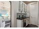 Butler's pantry featuring glass-front cabinets and black countertop at 618 Fairchild Dr, Highlands Ranch, CO 80126