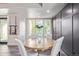 Cozy dining area features a round wooden table set for four, lit by natural light from nearby windows at 618 Fairchild Dr, Highlands Ranch, CO 80126