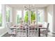 Bright dining room features large windows, modern lighting, and seating for six at 618 Fairchild Dr, Highlands Ranch, CO 80126