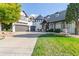Stunning home showcasing a turret entrance, charming landscaping, and attached garage with circular driveway at 618 Fairchild Dr, Highlands Ranch, CO 80126
