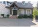 The front porch features brick accents, dark trim, an entry door, and seating area at 618 Fairchild Dr, Highlands Ranch, CO 80126