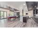 Spacious game room featuring a pool table, bar, dining area, and sliding door access to the patio at 618 Fairchild Dr, Highlands Ranch, CO 80126