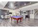 A game room with a pool table, and dining space under modern lighting, offers entertainment and relaxation at 618 Fairchild Dr, Highlands Ranch, CO 80126