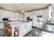 Modern white kitchen features a large island with seating and stainless steel appliances at 618 Fairchild Dr, Highlands Ranch, CO 80126