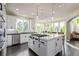 Open-concept kitchen features a large island with a cooktop, bar seating, and stainless steel appliances at 618 Fairchild Dr, Highlands Ranch, CO 80126
