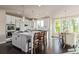 Spacious white kitchen features a large center island, stainless steel appliances, and adjacent breakfast nook at 618 Fairchild Dr, Highlands Ranch, CO 80126