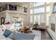 This living room features large windows, hardwood floors, and access to the kitchen at 618 Fairchild Dr, Highlands Ranch, CO 80126