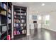Home office with dark wood floors, built-in bookcases and a desk with a computer at 618 Fairchild Dr, Highlands Ranch, CO 80126