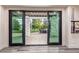 Indoor view of an outdoor patio showcasing a black framed sliding door leading to outdoor seating area at 618 Fairchild Dr, Highlands Ranch, CO 80126