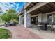 Outdoor patio space with stone pavers and seating areas for dining and lounging at 618 Fairchild Dr, Highlands Ranch, CO 80126