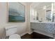 Powder room boasts a vessel sink, mosaic tile, and decorative mirror at 618 Fairchild Dr, Highlands Ranch, CO 80126