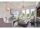 Cozy sitting room filled with natural light boasts elegant decor and comfortable seating at 618 Fairchild Dr, Highlands Ranch, CO 80126