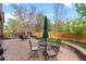 Spacious backyard patio area featuring a fire pit, outdoor seating, and barbecue grill for entertaining guests at 12017 W Cross Dr, Littleton, CO 80127