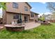 Back patio features a built-in grill, fire pit, and well-manicured lawn at 12017 W Cross Dr, Littleton, CO 80127