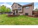 Expansive backyard featuring a well-manicured lawn, outdoor seating, and a cozy fire pit area for relaxation at 12017 W Cross Dr, Littleton, CO 80127