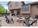 Entertainer's backyard with fire pit, built-in seating, grill, and patio set, ideal for outdoor gatherings at 12017 W Cross Dr, Littleton, CO 80127