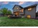 Spacious backyard features a fire pit, patio, and ample green space for outdoor enjoyment at 12017 W Cross Dr, Littleton, CO 80127