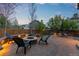Backyard features a gorgeous stone patio, outdoor fire pit, and mature trees at 12017 W Cross Dr, Littleton, CO 80127