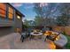 Backyard features a gorgeous stone patio and outdoor fire pit at 12017 W Cross Dr, Littleton, CO 80127