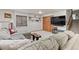 Inviting finished basement with comfortable seating, large screen television, and ample storage space at 12017 W Cross Dr, Littleton, CO 80127