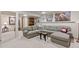 Cozy finished basement living area featuring a large sectional sofa, perfect for relaxing or entertaining at 12017 W Cross Dr, Littleton, CO 80127