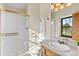 Bright bathroom featuring a glass shower, vanity, and natural lighting at 12017 W Cross Dr, Littleton, CO 80127