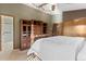 Primary bedroom featuring wooden floors, storage furniture, and ensuite bathroom at 12017 W Cross Dr, Littleton, CO 80127