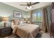 Comfortable bedroom with a ceiling fan and a window with blinds at 12017 W Cross Dr, Littleton, CO 80127