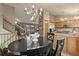 Dining area showing chandelier and connection to kitchen at 12017 W Cross Dr, Littleton, CO 80127