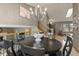 Formal dining room boasts chandelier, wood floors, and seating for six at 12017 W Cross Dr, Littleton, CO 80127