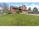 Charming two-story home with a well-maintained lawn and a two-car garage at 12017 W Cross Dr, Littleton, CO 80127