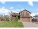 Charming two-story home with a well-maintained lawn and a two-car garage at 12017 W Cross Dr, Littleton, CO 80127