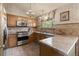 Well-equipped kitchen with stainless steel appliances, granite countertops, and ample cabinet space at 12017 W Cross Dr, Littleton, CO 80127