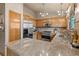 Functional kitchen with stainless steel appliances, granite countertops, and a refrigerator at 12017 W Cross Dr, Littleton, CO 80127