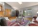 Inviting living room with hardwood floors, vaulted ceiling, and natural light from large windows at 12017 W Cross Dr, Littleton, CO 80127