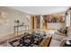 Spacious living room features hardwood floors, neutral paint, and a glass coffee table at 12017 W Cross Dr, Littleton, CO 80127