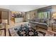 Comfortable living room with hardwood floors, large windows, and open layout at 12017 W Cross Dr, Littleton, CO 80127