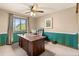 Well-lit office space with large wooden desk and comfortable chair, perfect for working from home at 12017 W Cross Dr, Littleton, CO 80127