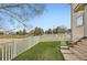 The fenced backyard features a green lawn and access to a scenic view, enhancing privacy and tranquility at 3805 E 106Th Ave, Thornton, CO 80233