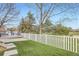 This backyard boasts a well-maintained lawn, complemented by a white picket fence, creating a serene outdoor space at 3805 E 106Th Ave, Thornton, CO 80233