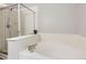 Relaxing bathroom featuring a soaking tub and glass-enclosed shower at 3805 E 106Th Ave, Thornton, CO 80233