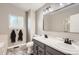 Well-lit bathroom with double sink vanity, and modern fixtures at 3805 E 106Th Ave, Thornton, CO 80233