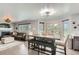 Open-concept dining area with modern furnishings, a large table, and seamless flow to the living room, ideal for entertaining at 3805 E 106Th Ave, Thornton, CO 80233