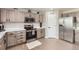 Well-designed kitchen features stainless steel appliances, gray cabinets, and ample counter space, perfect for cooking and entertaining at 3805 E 106Th Ave, Thornton, CO 80233