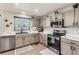 Functional kitchen with stainless steel appliances, updated cabinetry, and modern finishes, providing a practical and stylish cooking space at 3805 E 106Th Ave, Thornton, CO 80233