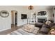 Inviting living room featuring a fireplace, stylish rug, and modern light fixture at 3805 E 106Th Ave, Thornton, CO 80233